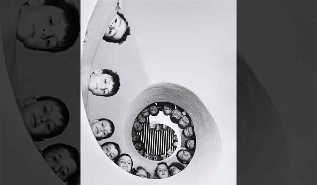 children ascending a spiral staircase in the newly built children’s library in Clamart, France