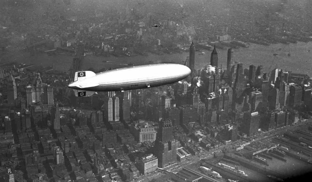 the German airship Hindenburg flying over New York City