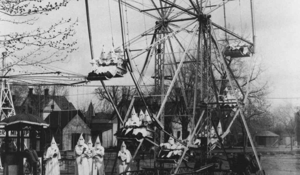 Members of the Ku Klux Klan riding on a Ferris wheel