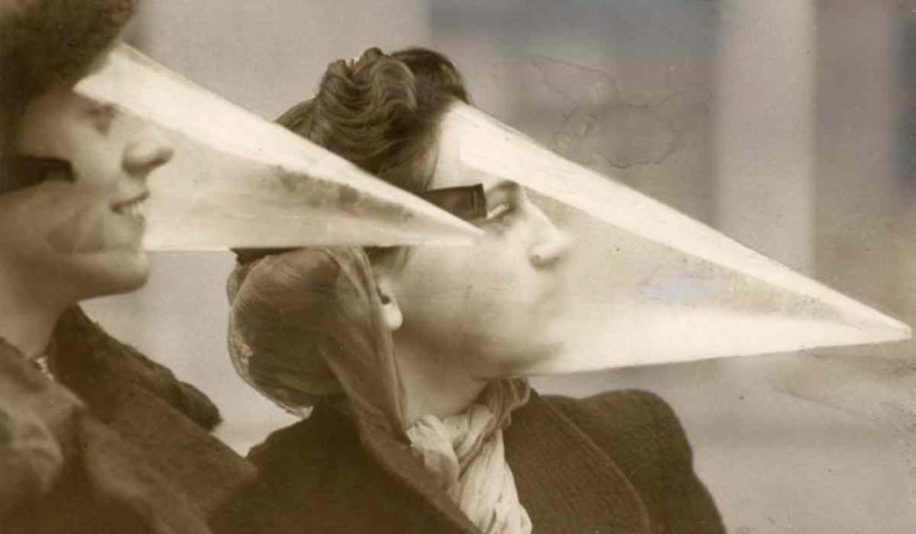 women wearing cone shaped plastic headgear to shield themselves from snowstorms
