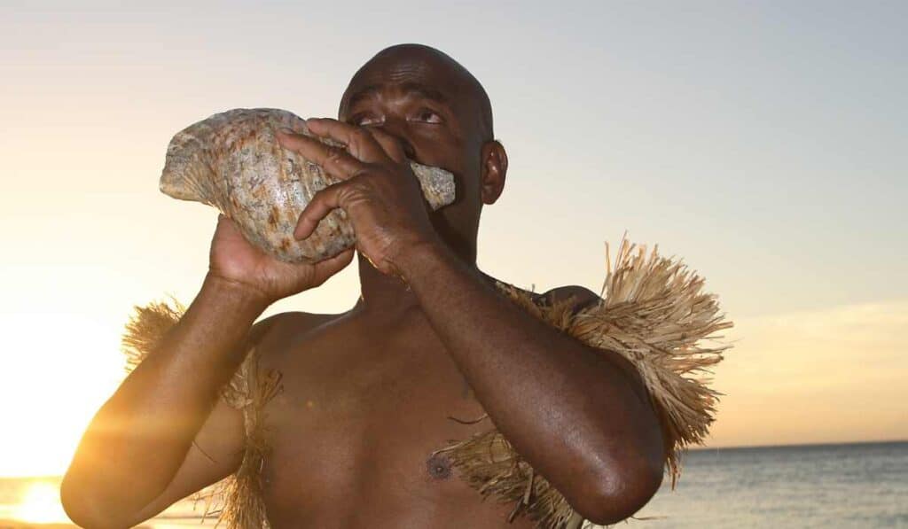 Blowing A Shell Horn In Hawaii During Weddings